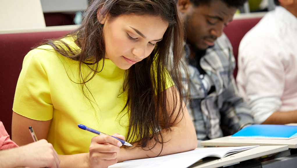 Abec College Student In Class Writing